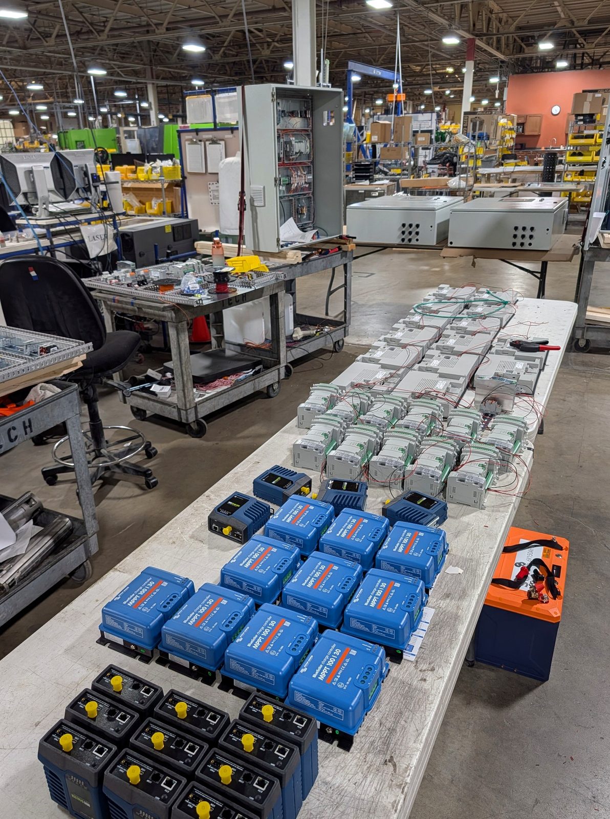 Batches of control modules being assembled on a workbench