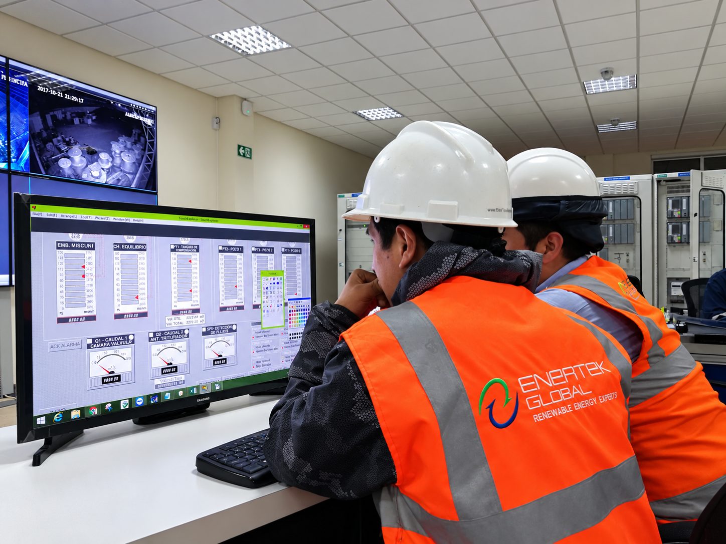 Engineers at a SCADA workstation in a control room